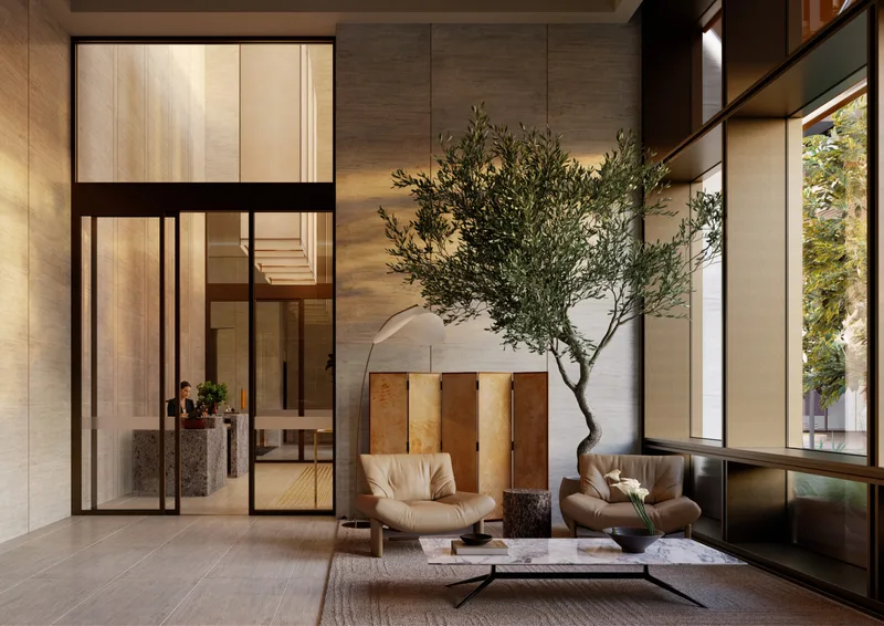 Artist’s impression of the AURA ground floor lounge, with leather armchairs and a marble table beneath a mature olive tree, the concierge desk visible through glazed doors