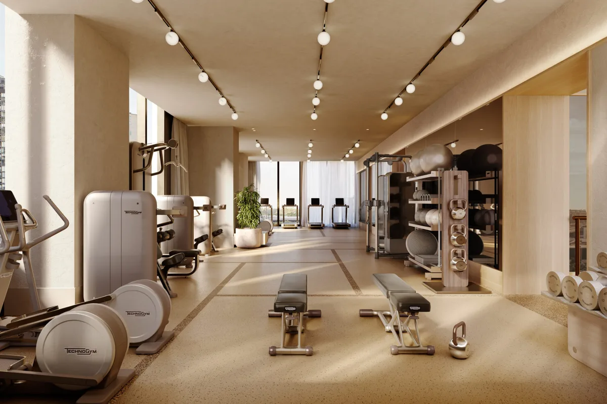 Artist’s impression of the AURA residents gym, a long light-filled room of Technogym equipment with floor to ceiling windows at the far end