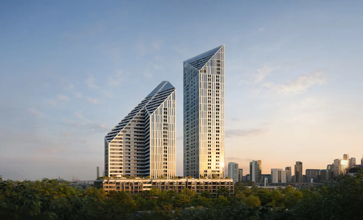 The development’s towers at dusk, the Melbourne city skyline behind