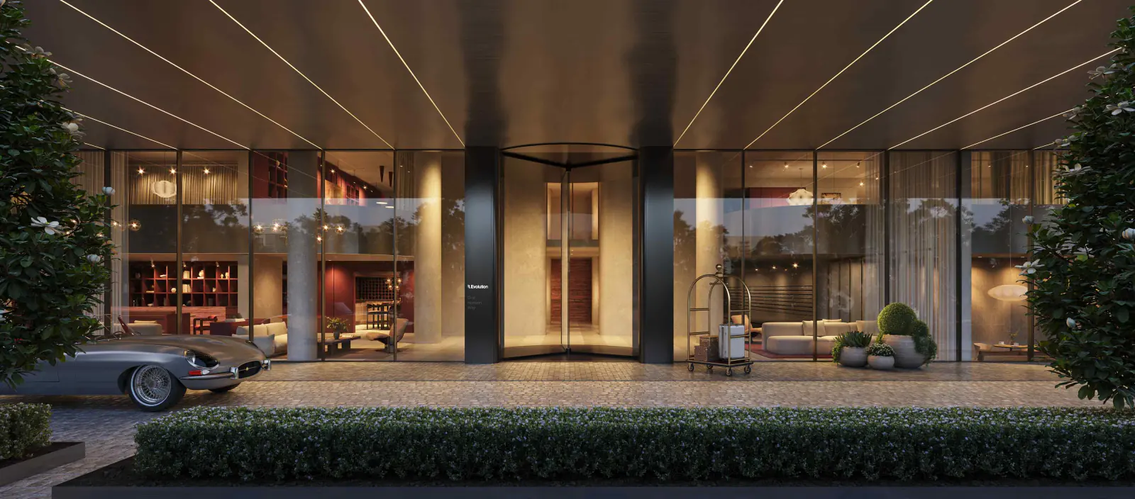 The lit porte-cochere and lobby entrance after dark