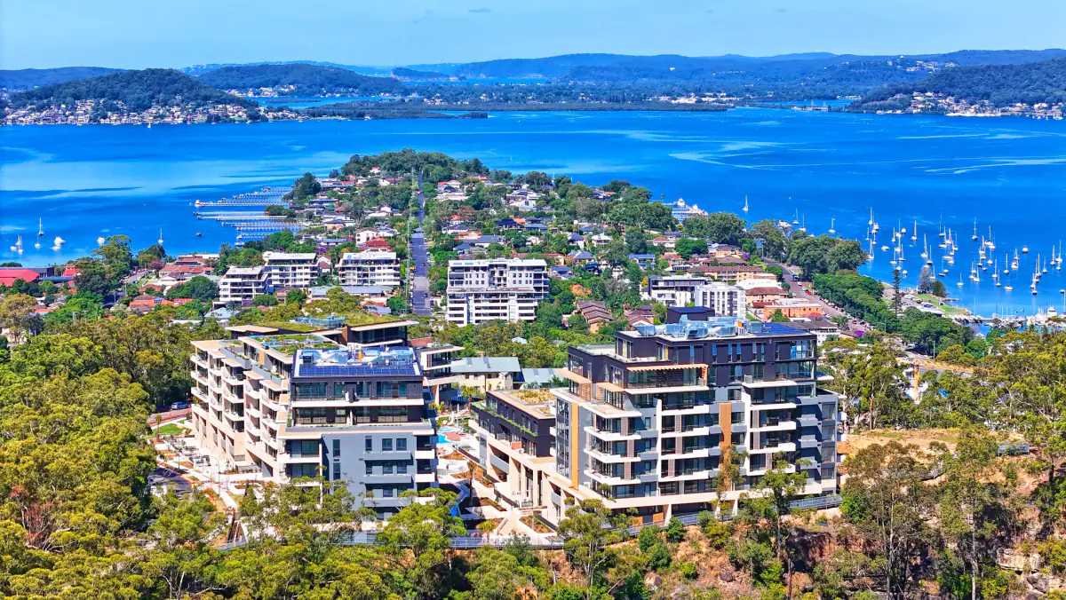 Aerial view of Rumbalara Residences on its hilltop above Brisbane Water, yachts moored below
