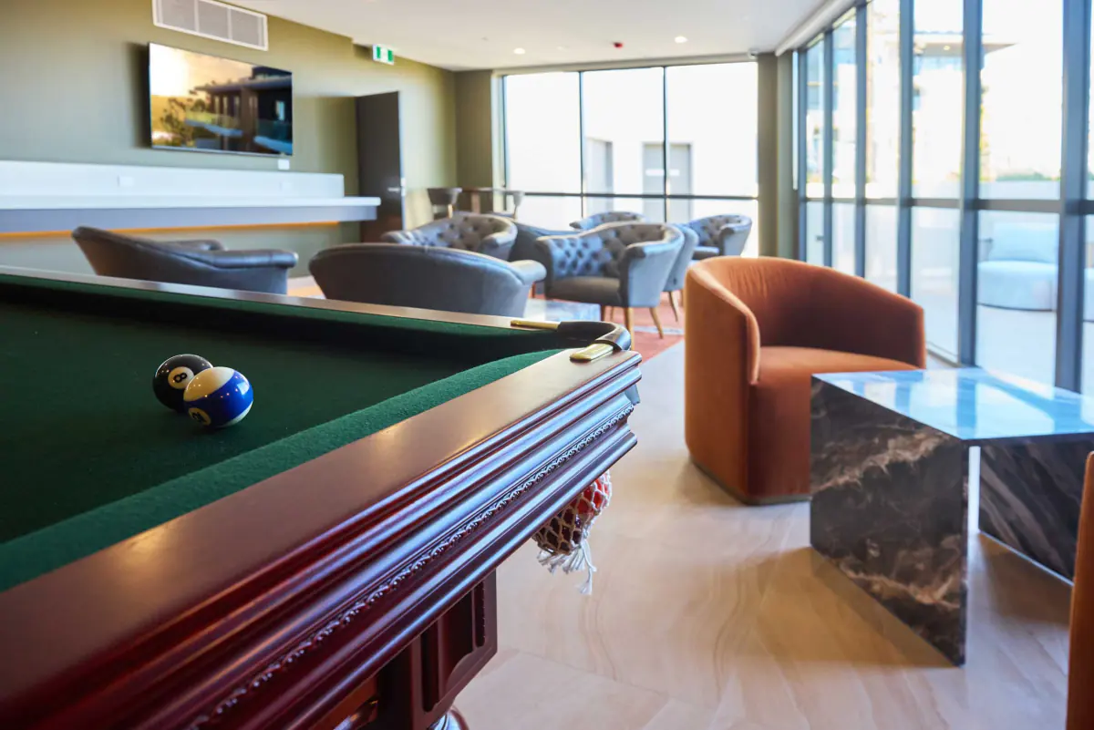 The residents’ lounge at Rumbalara Residences, with a billiard table and lounge seating
