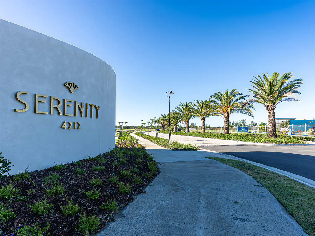 The Serenity 4212 entry monument on a palm-lined boulevard